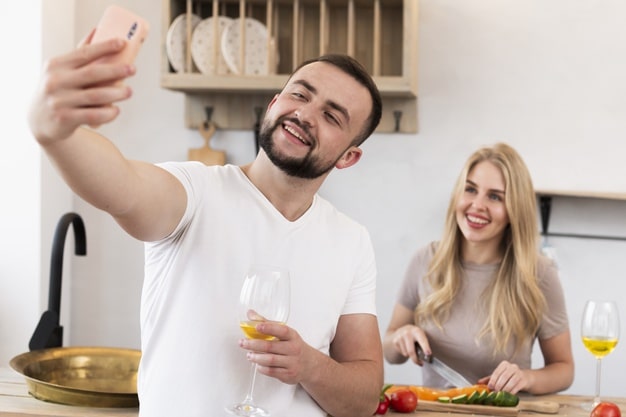 happy-couple-taking-selfie-kitchen_23-2148341730