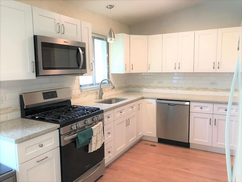 white cabinets, grey quartz cabinets, vinyl flooring black stainless Steel appliances
